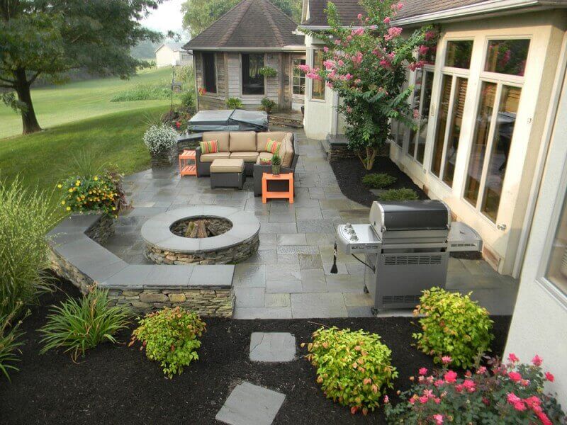 Backyard patio finished in multi-color stamped concrete with a stone pattern