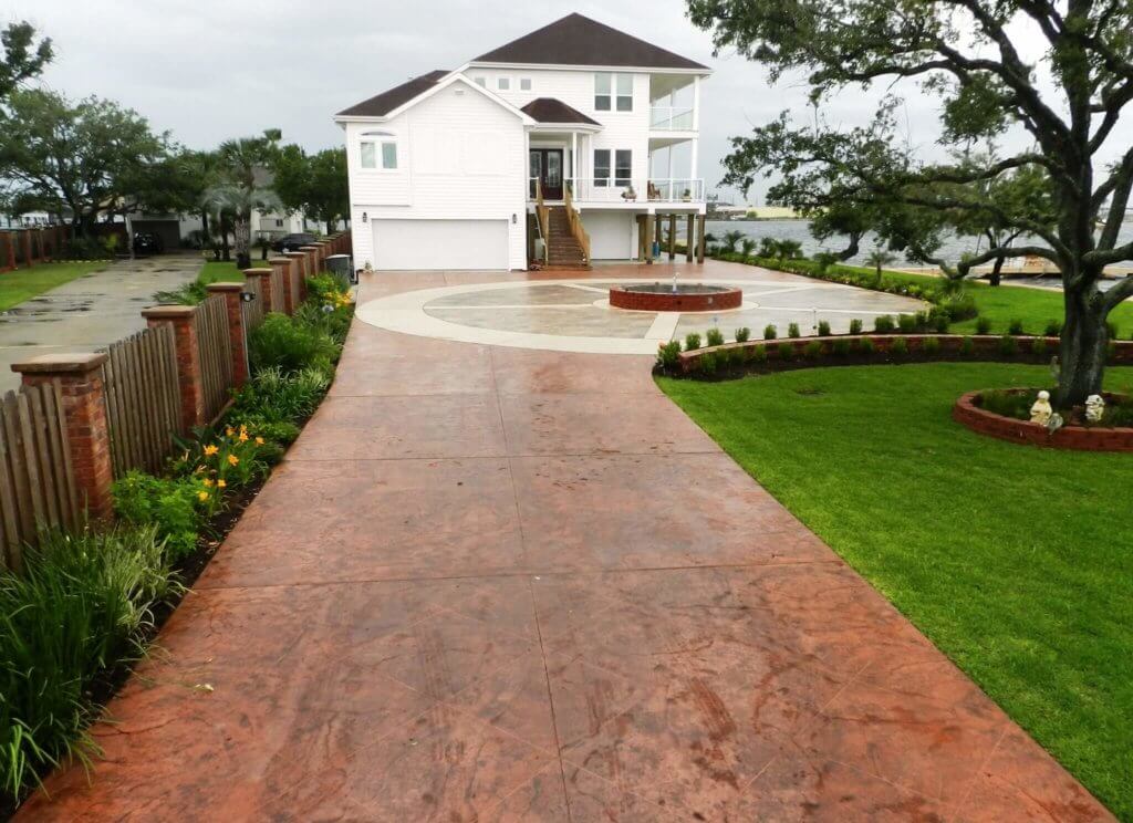 Finished stamped concrete driveway in front of a two-car garage